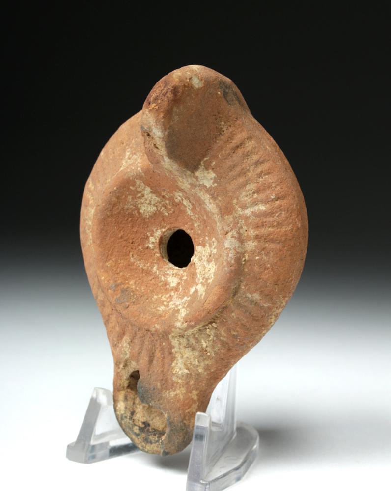 Roman Holy Land Redware Oil Lamp - Planta Pedis: **Originally Listed At $100** Roman, Roman Holy Land, ca. 3rd to 4th century CE. A petite mold-made terracotta oil lamp. It has a ring base with a shallow and illegible planta pedis (maker's mark), sm