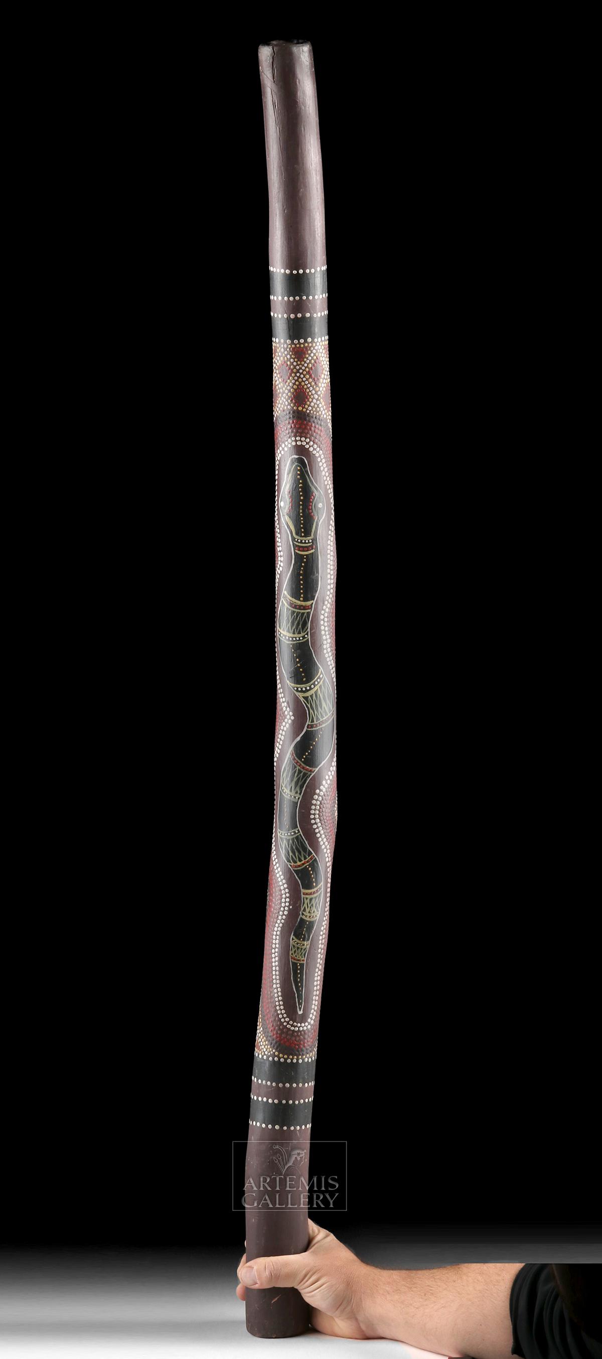 Mid-20th C. Australian Aboriginal Wooden Didgeridoo: **Originally Listed At $550** Oceania, Australia, Aboriginal culture, ca. mid to late 20th century CE. A hand-carved wooden didgeridoo of a lightly-curved tubular form, with rounded edges along the mo