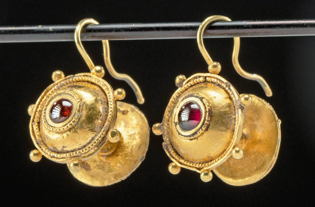 Roman 22K+ Gold Earrings Garnet Cabochons (pr): Roman, Imperial, ca. 1st to 3rd century CE. A matching pair of 93% gold (equivalent to 22K+) and garnet cabochon earrings. Each earring presents two lavishly embellished hemispheres, one at the front 