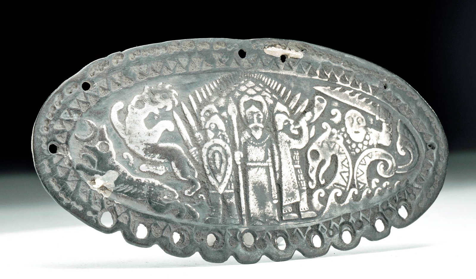 Rare 11th C. Viking Silver Ornament Battle Scene: Northern Europe, Viking or Viking Rus, ca. 1000 to 1100 CE. A fascinating ovoid 99% silver ornament featuring a dramatic scene of battle, with the god Freyr at center. He is at the helm of his ship, b