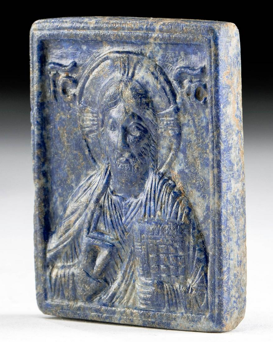 Important 12th C. Byzantine Lapis Lazuli Plaque Christ: Byzantium, Late Byzantine, ca. 12th century CE. A fine lapis lazuli plaque, skillfully carved with an image of Jesus Christ as Pantocrator holding an open Gospel book in His left hand and making a ges