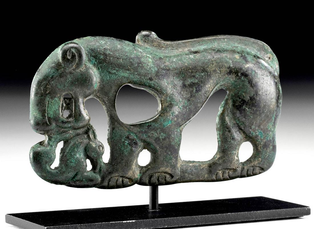 Published Eurasian Bronze Openwork Tiger Belt Plaque: Central Asia/Eurasia, Ordos culture or a neighboring group, ca. 6th to 4th centuries CE. A dramatic openwork belt plaque, made to be attached to a leather or cloth backing, depicting a feline attackin