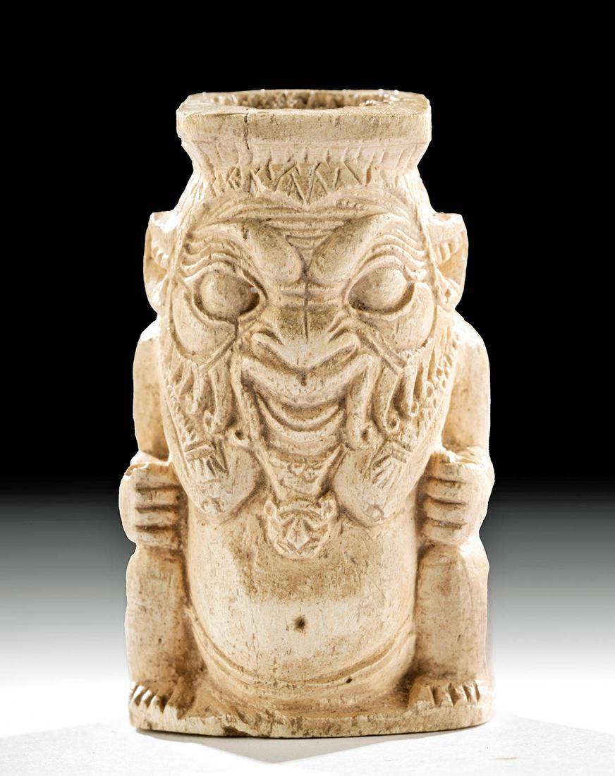 Rare Egyptian Bone Cosmetic Vessel Bes / Dwarf Deity: Egypt, Late Dynastic to Ptolemaic Period, ca. 664 to 30 BCE. An exceedingly rare cosmetic vessel carved from cow or ox bone depicting the Bes, the bow-legged dwarf deity of cosmetics and a protector o