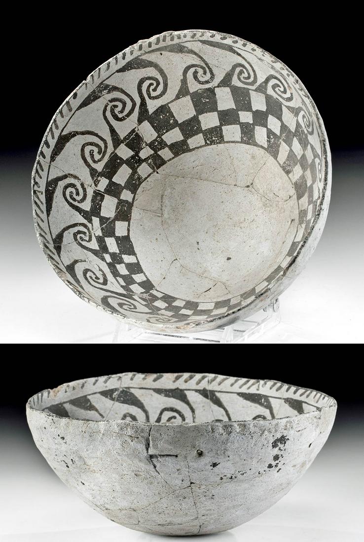 Mimbres Black-on-White Pottery Bowl w/ Spirals: Native American, Southwest, New Mexico, Mimbres Valley, ca. 1050 to 1250 CE. A graceful black-on-white Mimbres vessel decorated with painted motifs on its interior: a ring of interlocking spirals, the