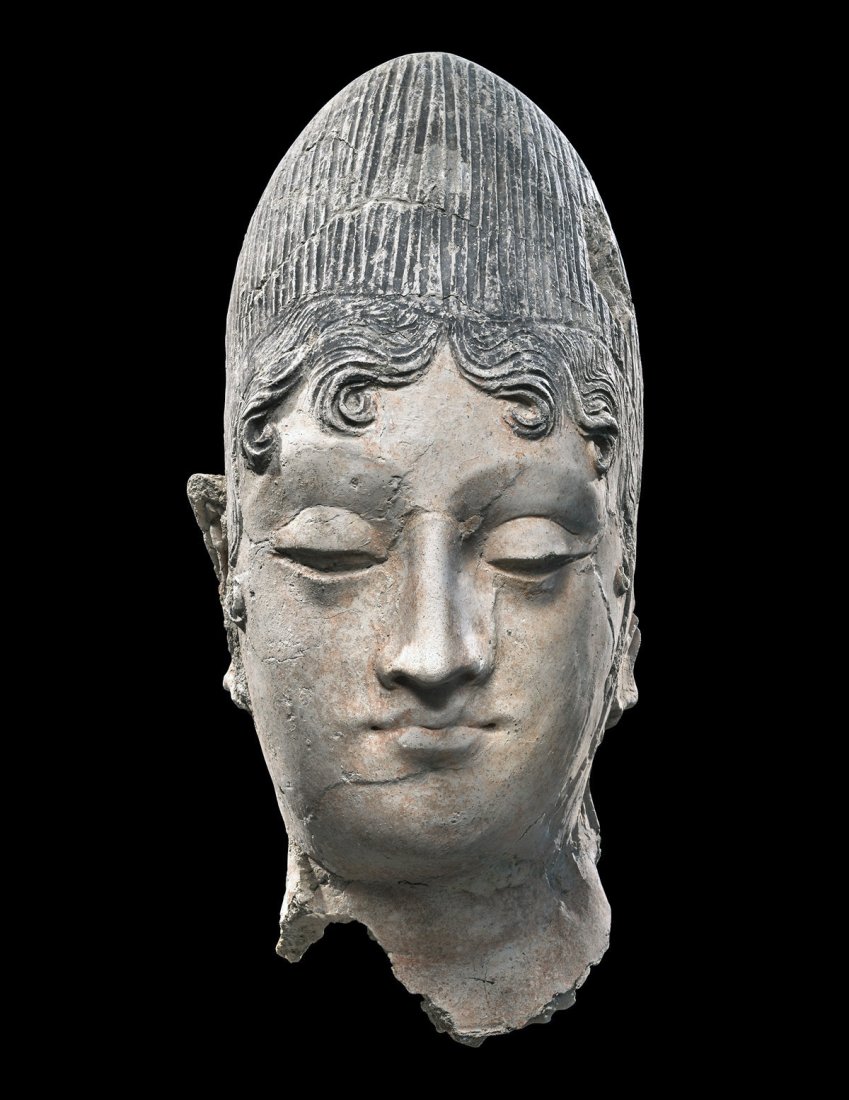 Gandharan Stucco: Central Asia, India / Pakistan, Gandharan Empire, ca 2nd to 5th century CE. A lovely stucco'd pottery head of a female. Long, thin face colored in original natural pink pigmentation, her eyes downcast