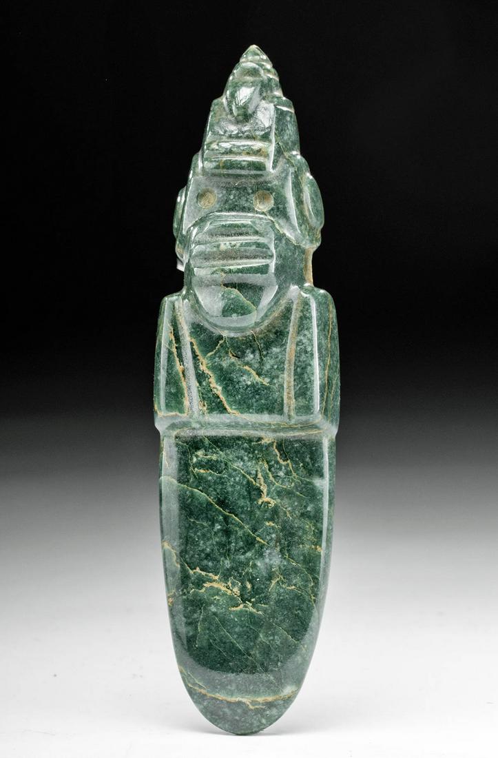 Costa Rican Jade Pendant - Avian w/ Bird Headdress: Pre-Columbian, Costa Rica, Guanacaste-Nicoya, ca. 250 to 800 CE. Finely carved and string cut from jadeite of rich verdant hues, an axe god celt presenting an avian visage with another bird atop his h