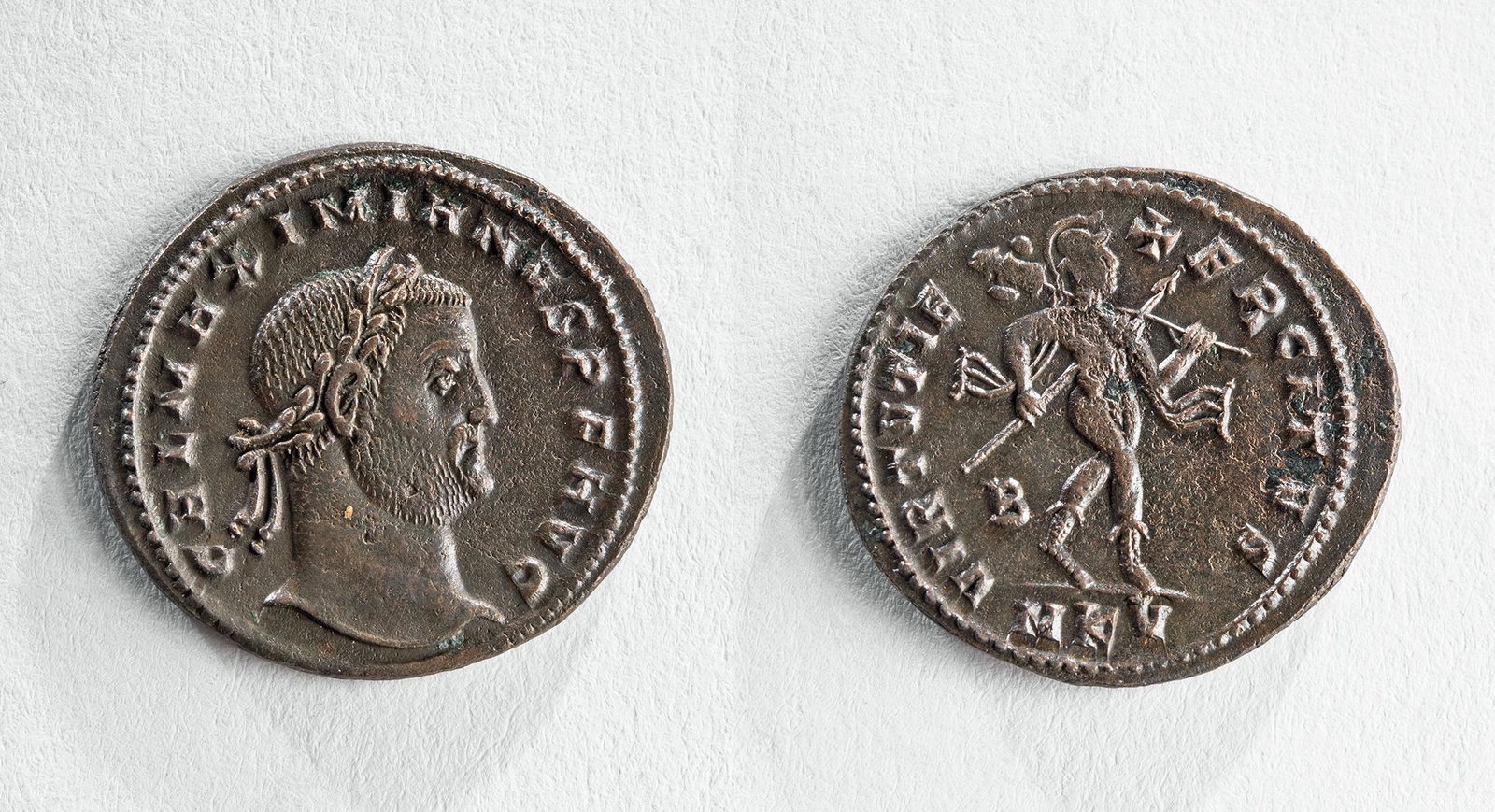 Roman Gallerius Bronze Follies Coin - 6.3 g: Roman, Imperial Period, Gallerius, ca. 305 to 311 CE. AE Follis. Cyzicus Mint, 309-310 CE. Obverse: Laureate head facing right. Reverse: Mars advancing r. holding spear, shield, and trophy over should