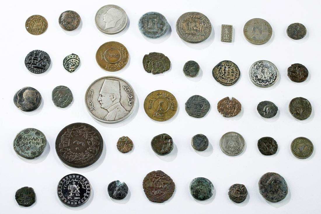 Lot of 38 Assorted Islamic Silver & Bronze Coins: Near East/Middle East, ca. 100 BCE to 20th century CE. A nice collection of thirty-eight assorted coins, the vast majority from the Middle East, including the Roman Holy Land, the Abbasids, the Seleuc