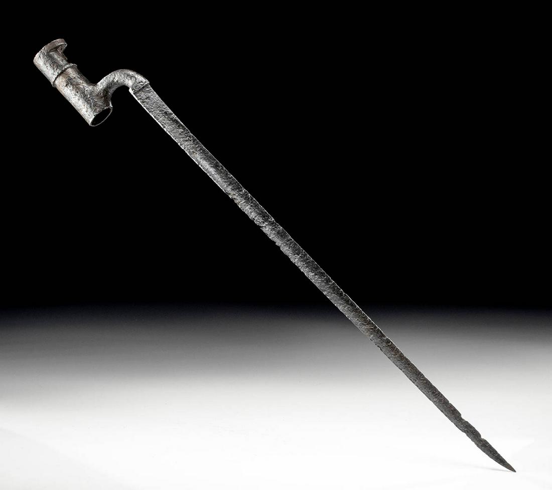 American Civil War Iron Bayonet: North America, United States of America, Civil War period, ca. 1861 to 1865 CE. A forged-iron bayonet blade with a triangular blade, a gently curved tip, and a sturdy arm projecting from the cylindric