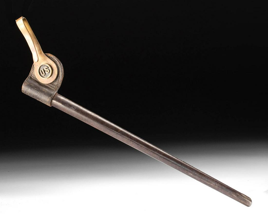 American M-1873 Steel, Leather & Brass Bayonet Scabbard: North America, United States, ca. 1873 CE. A tubular steel bayonet scabbard of a slender form with a rounded tip and a semicircular opening into the blade housing. Attached to the top of the scabbard 