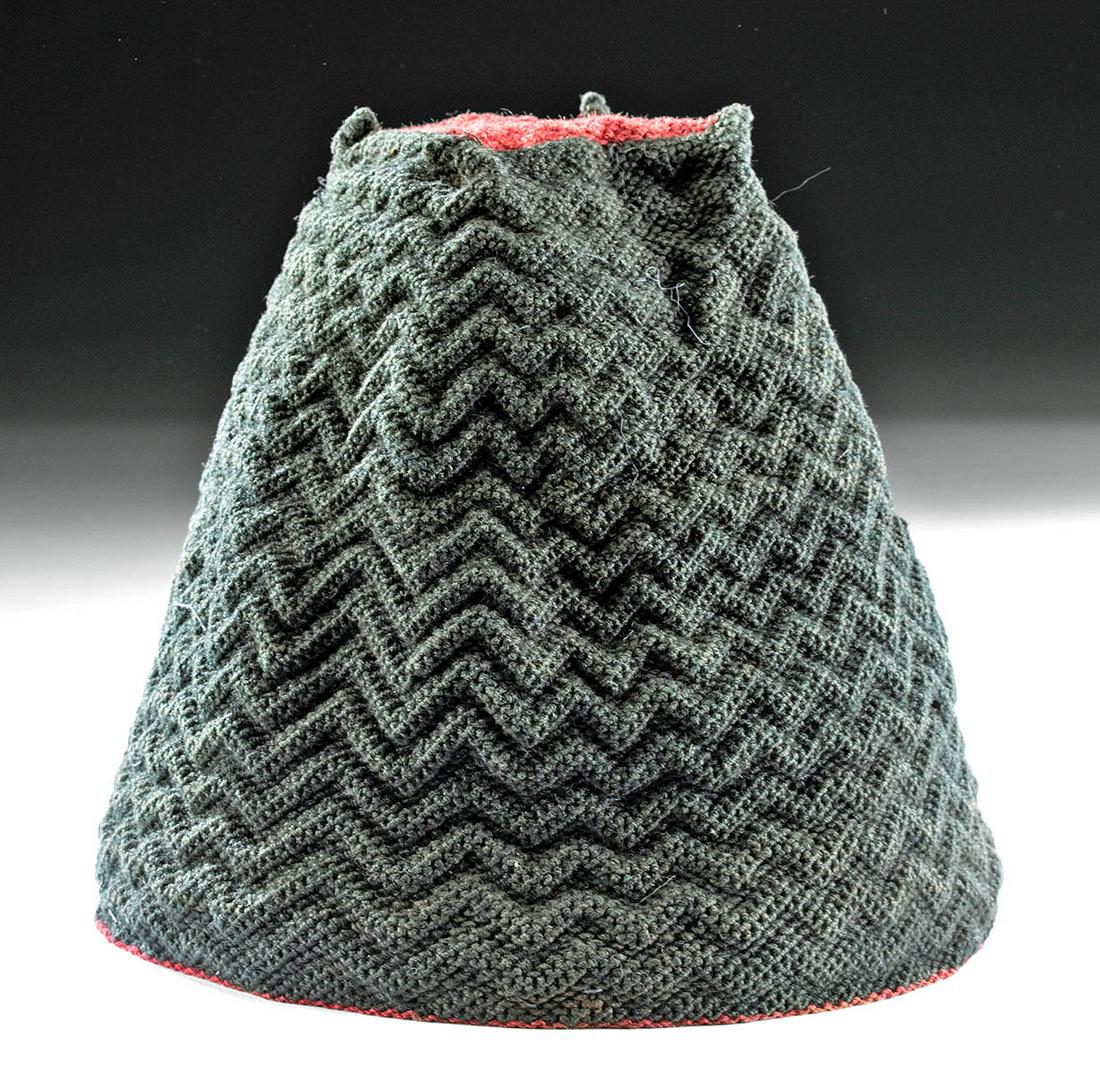 Tiahuanaco Camelid Fiber Four-Cornered Hat: Pre-Columbian, Chile, Tiahuanaco (also Tiwanaku), ca. 400 to 700 CE. A finely woven, four-cornered hat of a rather high form, featuring a square crown and pointed tips, the yarns dyed black for the pe