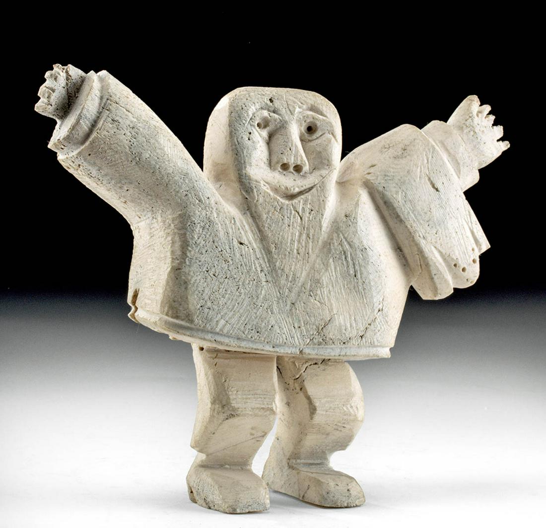 Early 20th C. Native American Inuit Bone Figure: Native American, northern Canada, Inuit peoples, ca. early to mid 20th century CE. A delightful human figure, carved from whale bone, featuring outstretched arms, a squared-off head, and smiling facia