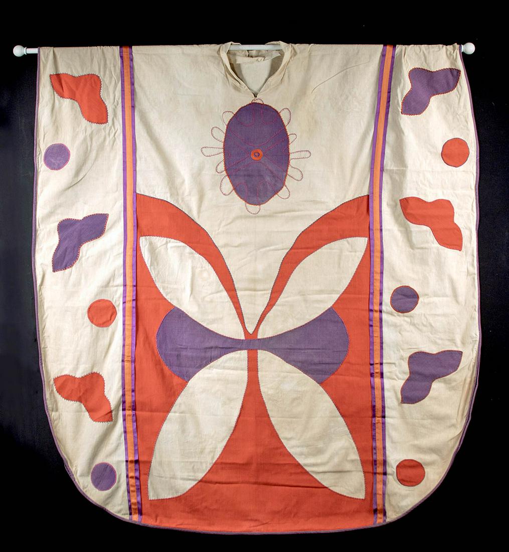 19th C. Tahitian Cotton Chasuble (for Catholic Priest): Polynesia, Tahiti, ca. 19th century CE. A colorful cotton chasuble, creamy white with large cotton patches of brilliant purple and red that resemble flying birds and butterflies. Bright orange ribbons