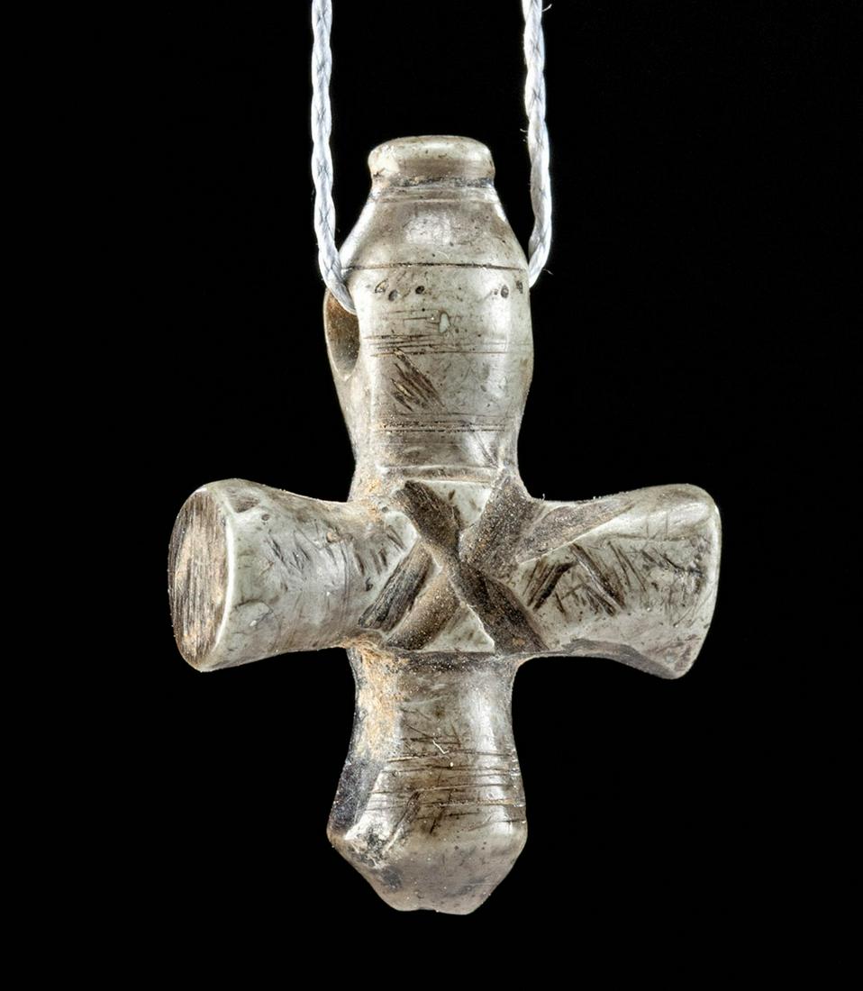 Byzantine Steatite Cross w/ Incised Motifs: Near East / Holy Land / Constantinople, Byzantine Empire, ca. 5th to 8th century CE. A painstakingly carved stone (steatite) cross pendant, with its upper vertical arm slightly longer than the others,