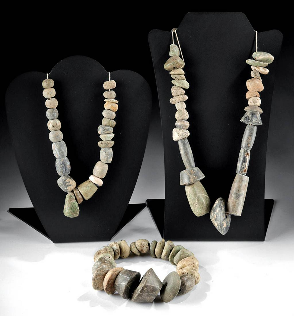 Lot of 3 Mezcala Guerrero Stone Bead Strands: Pre-Columbian, Mexico, Guerrero region, Mezcala culture, ca. 500 to 200 BCE. A fabulous ensemble consisting of 3 strands of hand-carved stone beads in hues of forest-green, dark-grey, beige, cream, ru