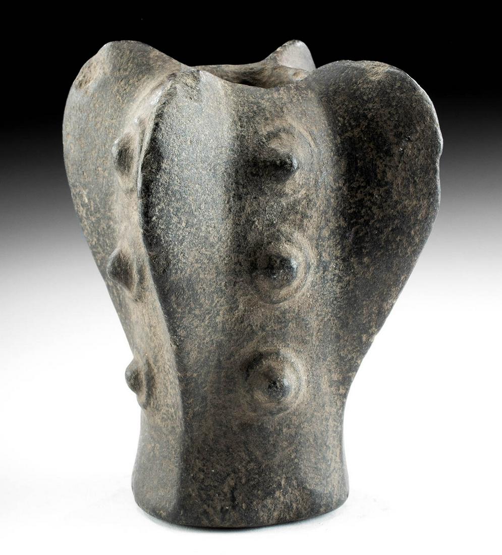 Chavin Stone Mace Head w/ Fins & Nodules: Pre-Columbian, north coast Peru, Chavin, ca. 900 to 500 BCE. A beautiful mace head carved from black-hued stone with a gradually expanding body, a cylindrical socketing shaft, four vertical fins proje