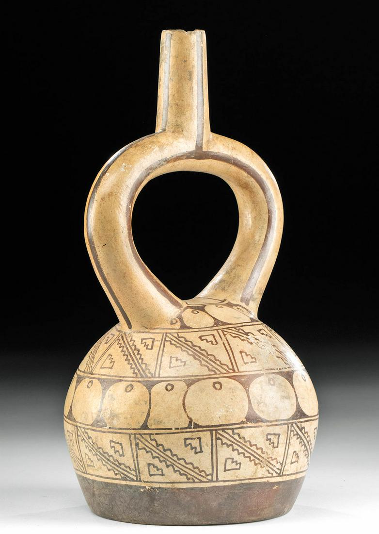 Moche Bichrome Stirrup Vessel Geometric Motifs: Pre-Columbian, North Coast Peru, Moche, Phase V, ca. 650 to 850 CE. A fine example of a hand-built pottery vessel with a flat base, a spherical body with a rounded shoulder, a stirrup-shaped handle of