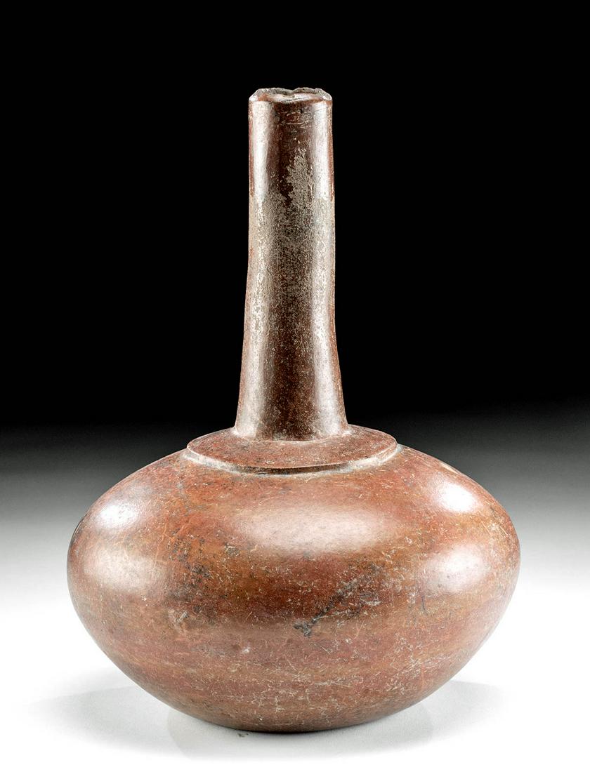 Colima Pottery Long-Neck Water Jug: Pre-Columbian, West Mexico, Colima, ca. 300 BCE to 300 CE. A particularly graceful and elegant redware vessel with an apple-shaped body that tapers to a small, nearly flat base, and a tall cylindrical