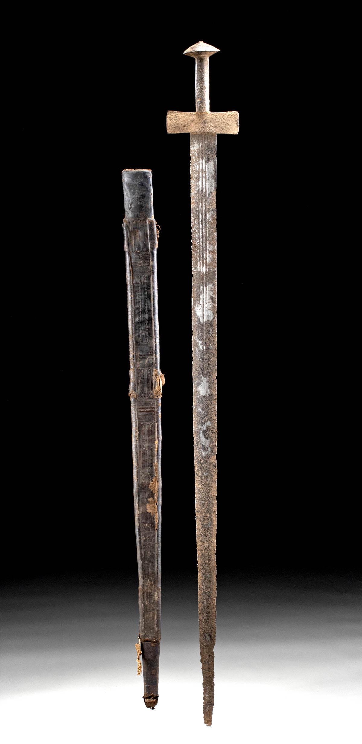 Late 19th C. Sudanese Iron Sword & Leather Sheath: Central Africa, Sudan, ca. late 19th century CE. A forged-steel sword of a traditional Sudanese style known as a kaskara. The tapered, double-edged blade features a trio of shallow fullers along the t