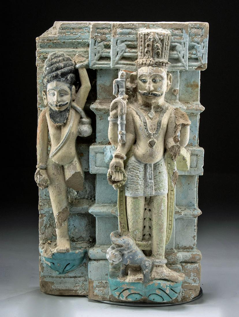 19th C. Indian Polychrome Stone Temple Relief Panel: Central Asia, India, ca. 19th century CE. A large, brightly painted stone relief panel from a temple, featuring a high relief standing god, probably Indra with his elephant mount, and an attendant bes