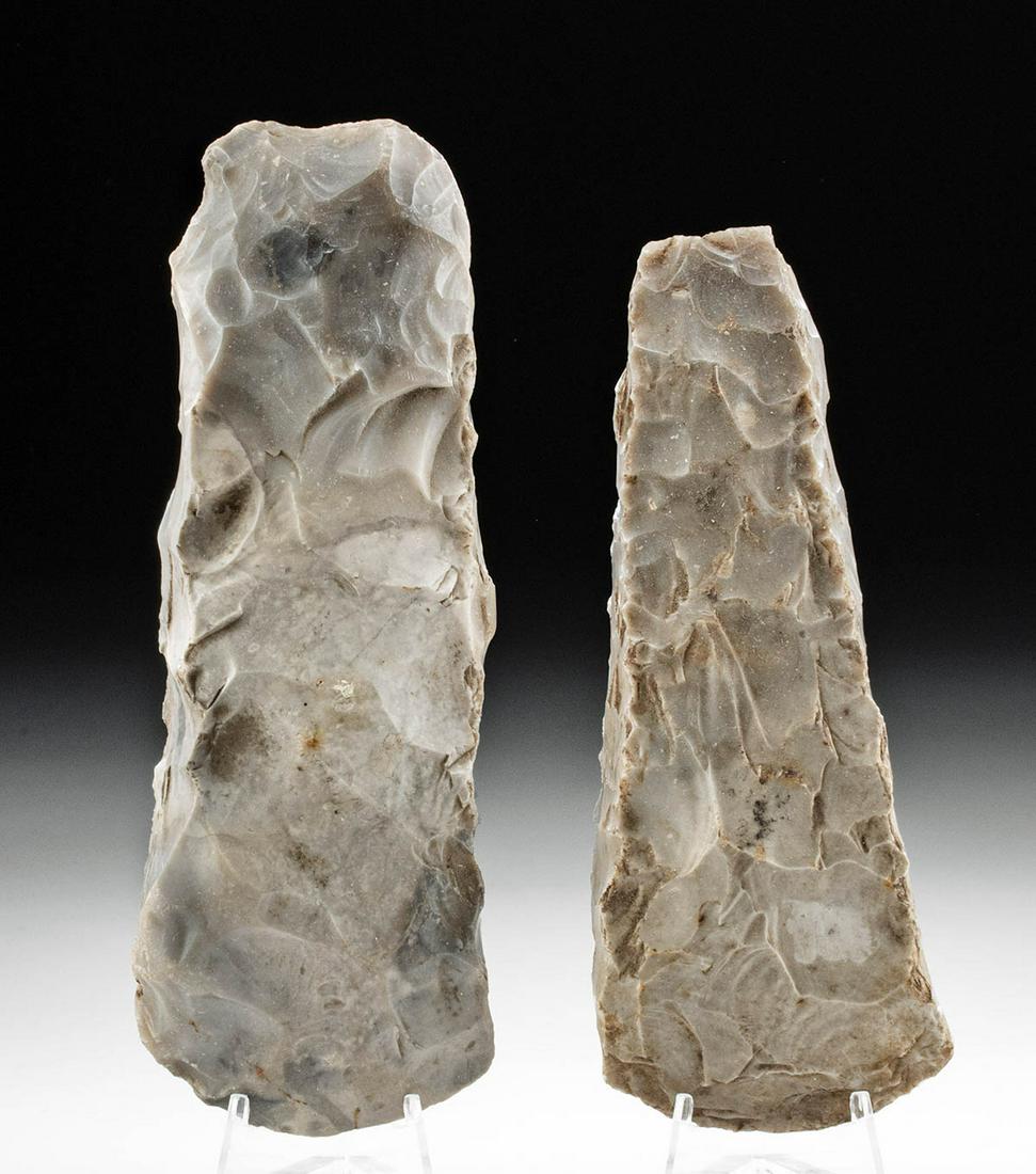 Lot of 2 Danish Neolithic Stone Axes: Northern Europe, Denmark, Neolithic period, ca. 3900 to 1700 BCE. A pair of chert hand axes, each with a thick butt, made from stone with mottled brown-grey hues. The polished flint axe is part of the