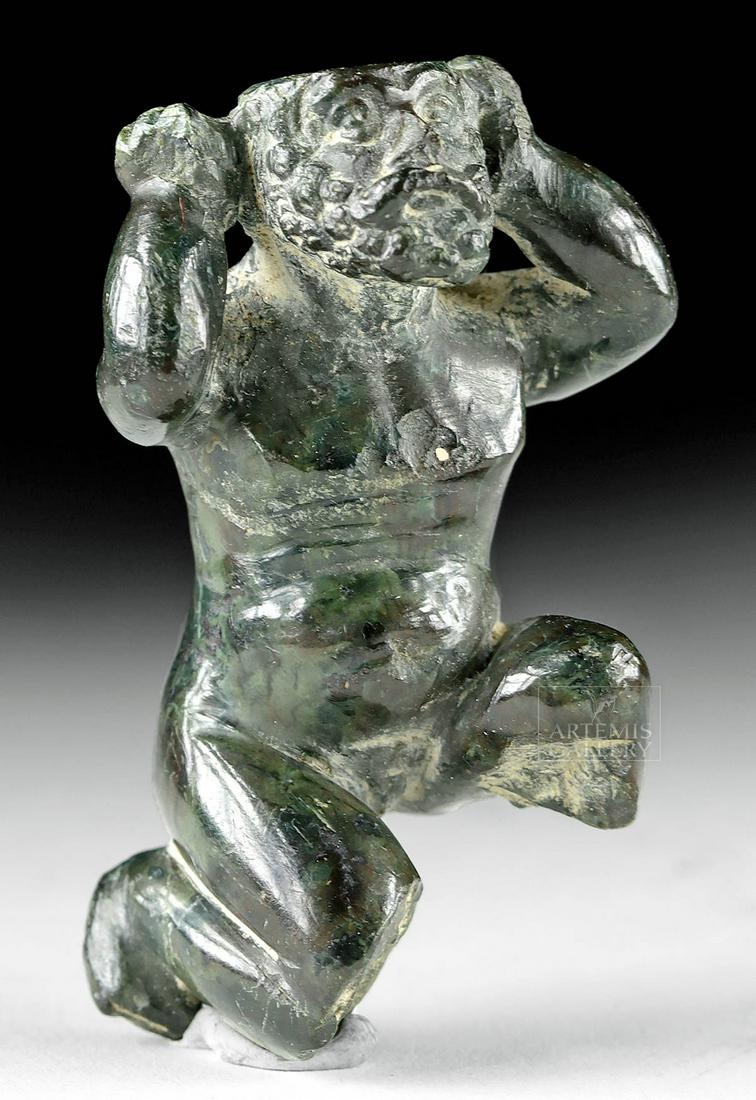 14th C. Italian Renaissance Stone Figure - Atlas: Western Europe, Italy, Renaissance, ca. late 14th to 16th century CE. A hand-carved, muscular, dark green stone figure of Atlas, shown crouching, his arms raised to support a globe. The top of his hea