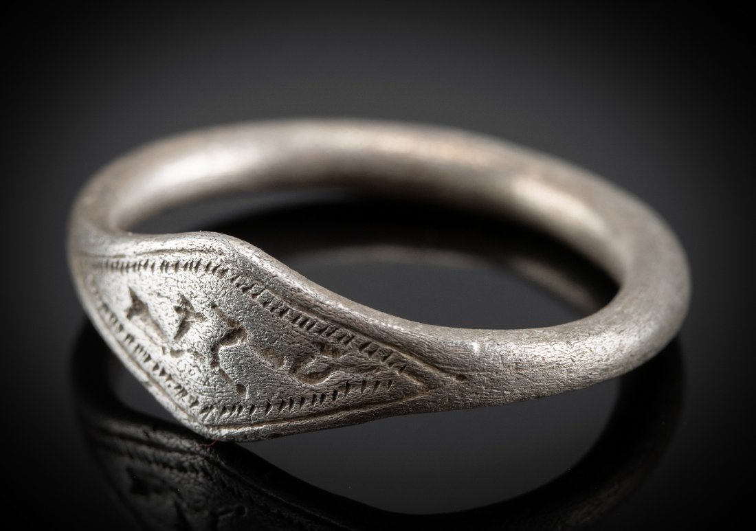 Greek Archaic Silver Ring w/ Deer - 3.8 g: Greece, Archaic Period, ca. 500 BCE. One of our favorites, a lovely 96% silver ring with a thin cylindrical band and a diamond-shaped face. The face is engraved with a motif that shows deer running in