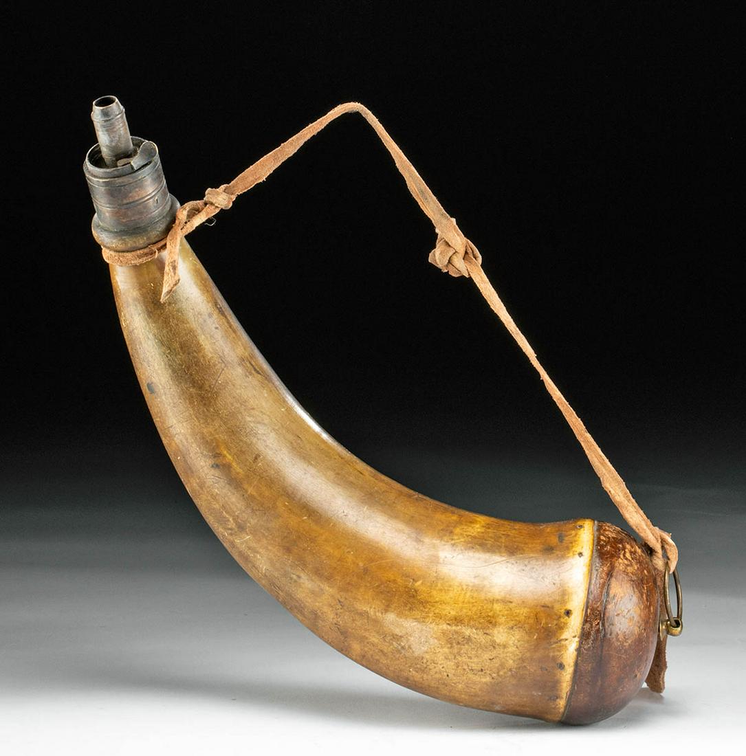 19th C. American Powderhorn: North America, United States, 19th century. A wonderful antique powderhorn comprised of a bison horn body with an elegant natural curve, a hardwood base-plug, and a brass spout. Finally, a strand of d