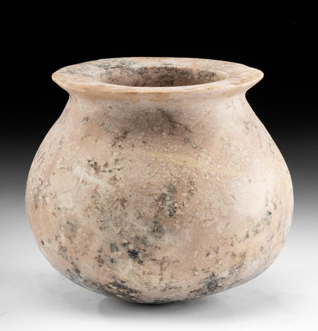 Early Dynastic Egyptian Pink Granite Rimmed Jar: Ancient Egypt, Early Dynastic to Old Kingdom Period, 1st to 6th Dynasty, ca. 3100 to 2181 BCE. A gorgeous jar with a round but stable base, a tapered shoulder, a corseted neck, and a flared rim, all h