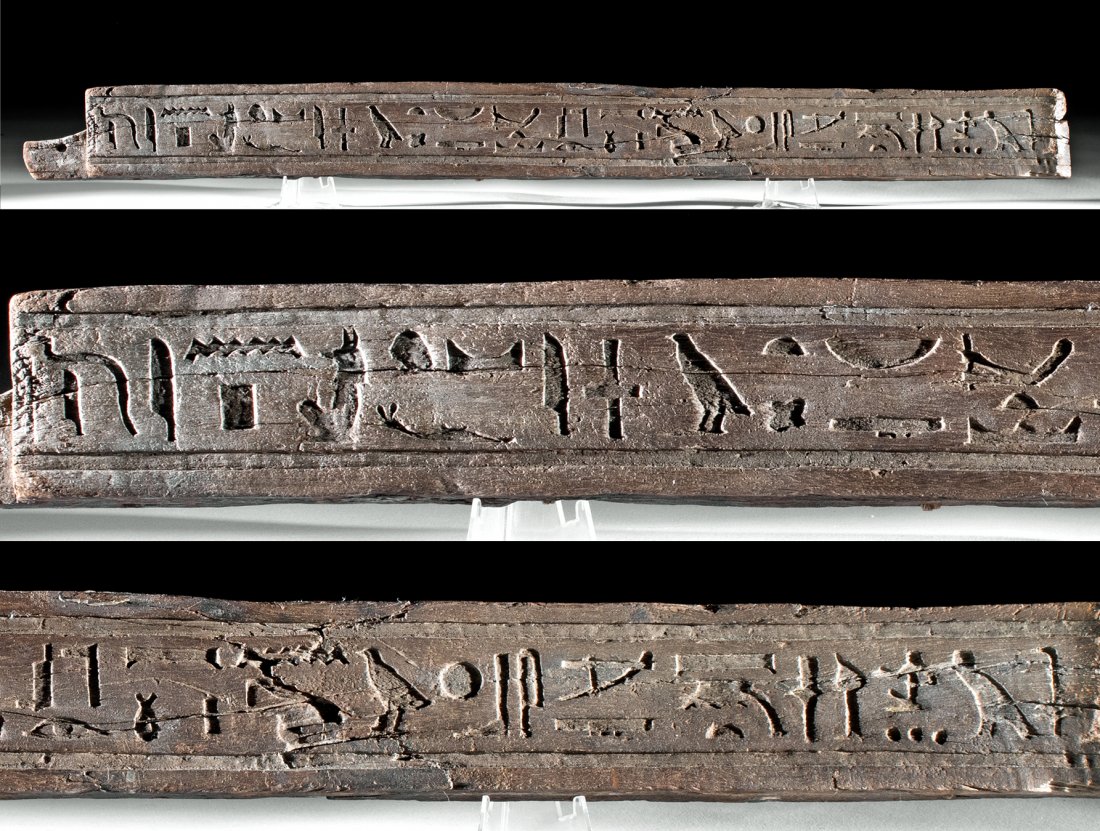 Translated Egyptian Wooden Coffin Panel Fragment: Ancient Egypt, Late Dynastic to Ptolemaic Period, ca. 664 to 30 BCE. A wonderful hardwood panel fragment from a Late Period coffin exhibiting an inscribed hieroglyphic register which contains a partia