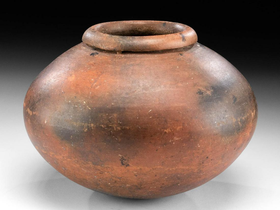 Fine Etruscan Redware Olla: Classical World, Etruria, ca. 5th century BCE. A wheel-thrown redware pottery olla of a slightly compressed spherical form with a round but stable base, a sloped shoulder, a gentle groove around the n