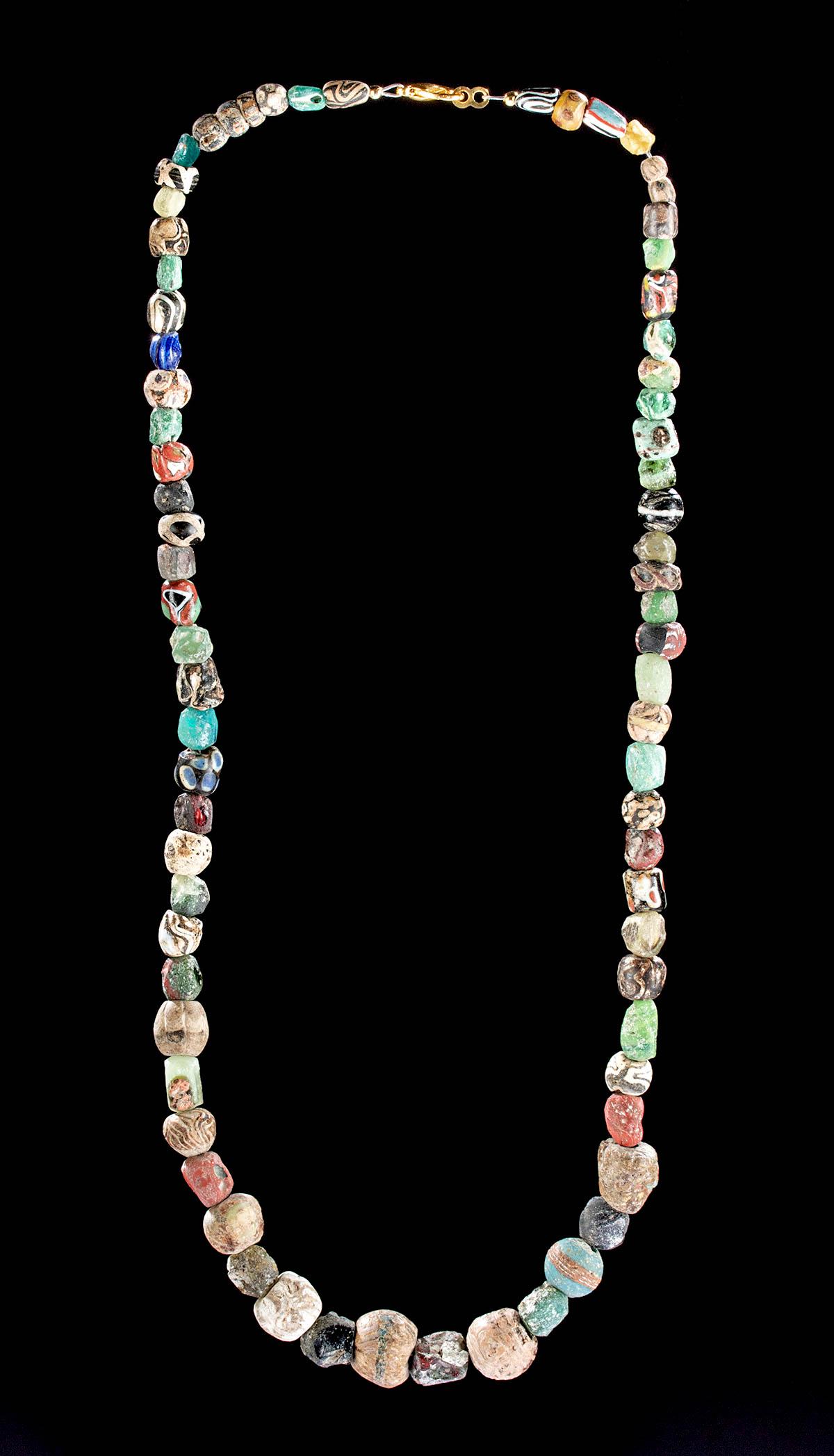 Wearable Necklace w/ Ancient Glass Beads: Roman and Ancient Near East, North Africa, Mali, Imperial period through early Islamic periods, ca. 200 to 900 CE. A striking strand of 39 hand-formed glass beads from the North African Roman Empire a