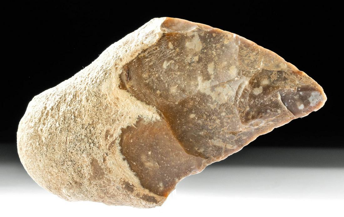 Spanish Neolithic Flint Hand Axe: Western Europe, Spain, Neolithic period, ca. 3900 to 1700 BCE. A hand-knapped flint hand axe of a hefty form with a triangular blade, a wide shoulder, and an un-knapped handle that has a great grippin