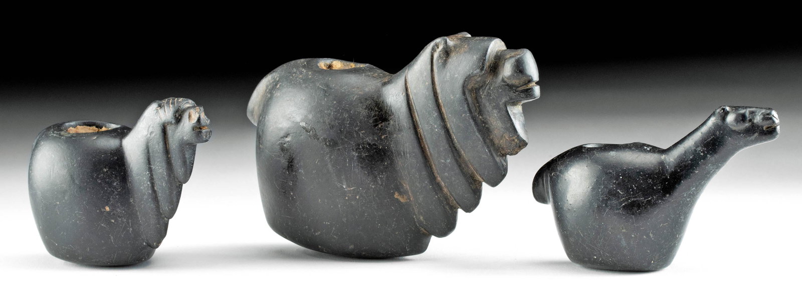 Lot of 3 Inca Stone Camelid Canopas: Pre-Columbian, north central Peru, Inca Empire, ca. 1470 to 1532 CE. A wonderful gathering of three ritual vessels known as canopa that are hand-carved from deep, black-hued stone. Each of the ritual 