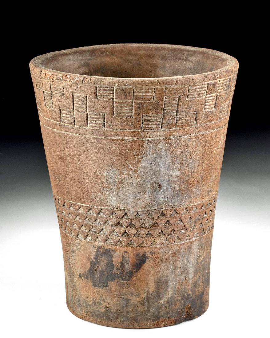 Fine Inca Incised Wooden Kero: Pre-Columbian, Peru, Inca, ca. 15th to early 16th CE. A wonderful Inca kero, carved from a single piece of wood to create a gracefully flared tumbler vessel, with incised geometric motifs likely inspi