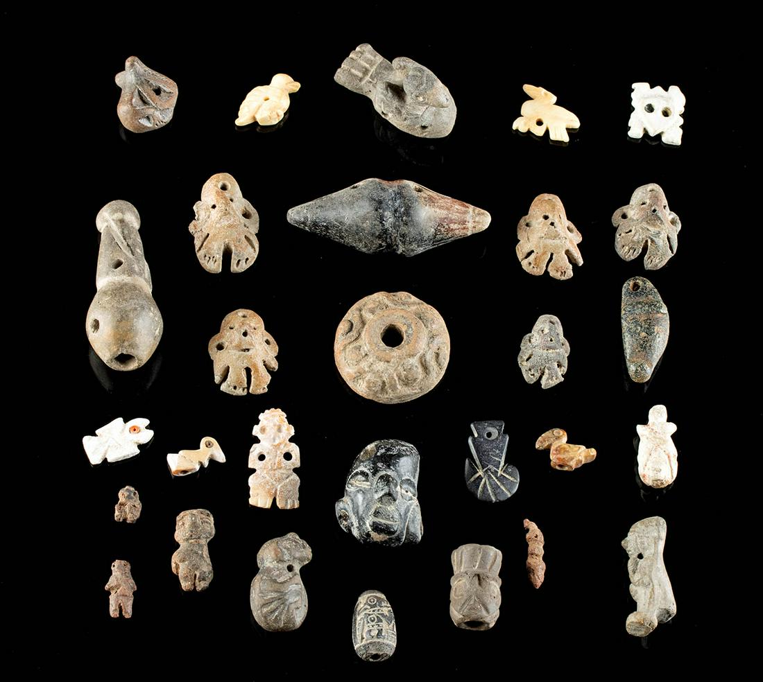 29 Pre-Columbian Shell & Pottery Amulets & Pendants: Pre-Columbian, West Mexico, Peru, and Ecuador, ca. 300 BCE to 1200 CE. A fine gathering of 29 amulets and pendants from across ancient Mesoamerica. First are 11 West Mexican pieces showing a conical p