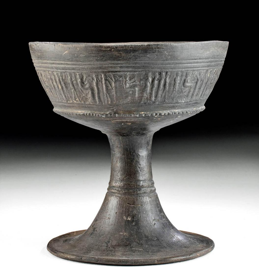 Etruscan Bucchero Pottery Chalice w/ Figural Scene: Classical World, Northern Italy, Etruscan culture, ca. 7th to 6th century BCE. A lovely Bucchero wheel-thrown pottery chalice of an elegant form comprised of a broad cup with a slender stem that gentl