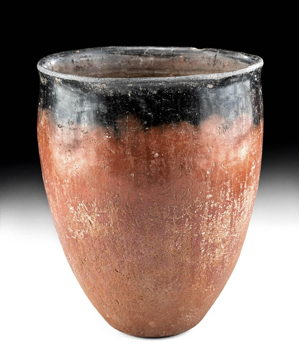 Very Fine Egyptian Pre-Dynastic Naqada Blacktop Vase: Ancient Egypt, Pre-Dynastic period, late Naqada I to early Naqada II, ca. 3600 to 3300 BCE. A gorgeous coil-formed Nile silt pottery vessel with a highly-burnished, russet-hued surface made with a thi