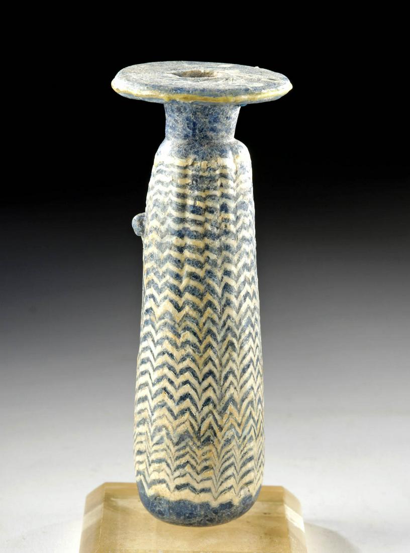Greek Hellenistic Core-Formed Glass Alabastron: Ancient Greece, Hellenistic, ca. 3rd to 1st century BCE. A striking core-formed glass alabastron, so named because many vessels that assumed this form were made of alabaster. This piece is comprised o