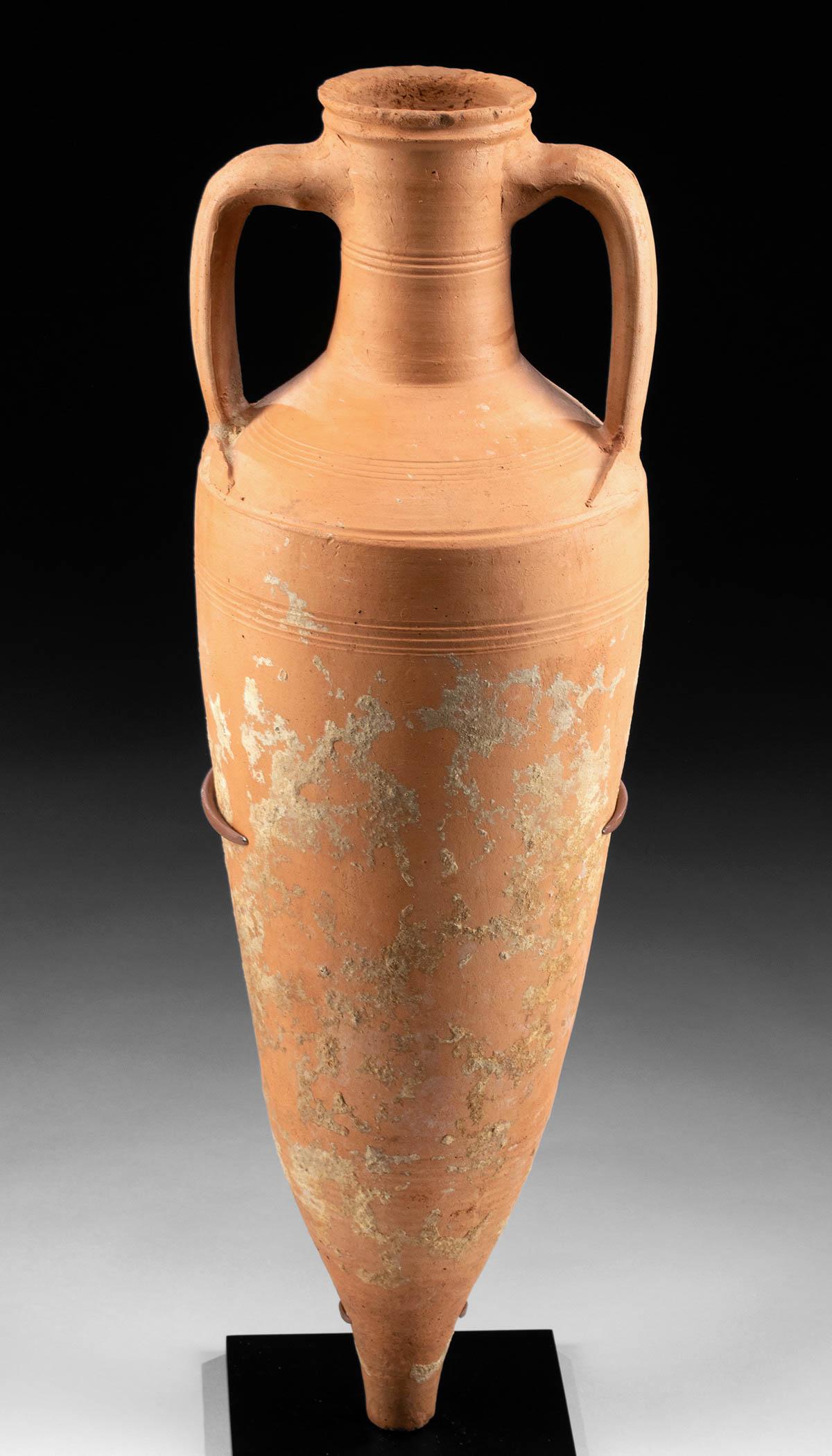 Roman North African Terracotta Transport Amphora: Roman Empire, North Africa, 3rd to 4th century CE. Rare to find in any condition, let alone in this state of preservation. Transport amphora, used for storing and shipping wine, oil and water througho