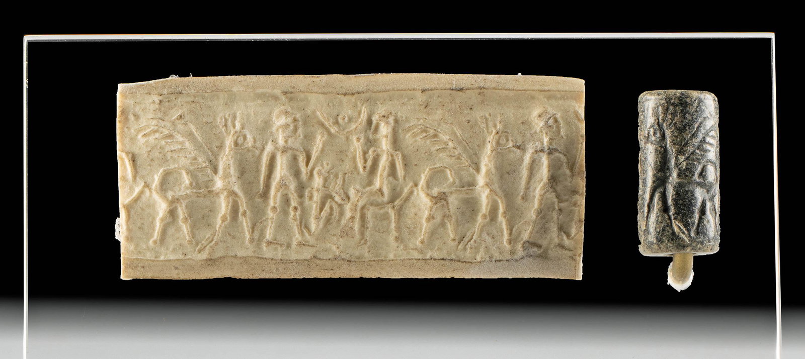 Neo-Babylonian Stone Cylinder Seal Bead: Ancient Near East, Neo-Babylonian Period, ca. mid 1st millennium BCE. A stone cylinder seal bead, hand-carved from a black matte stone, probably chalcedony, with complex iconography. A pegasus, shown