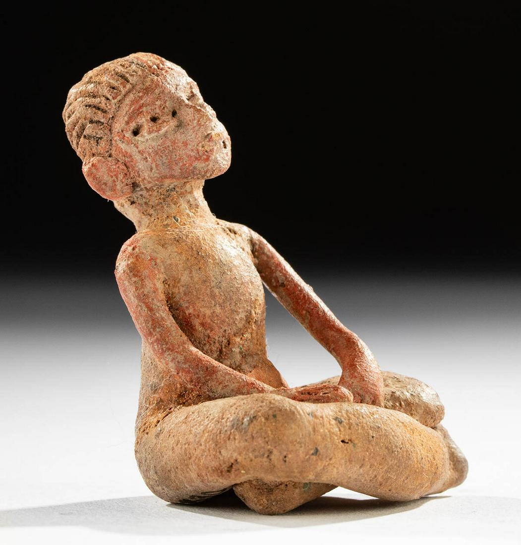 Guerrero Xalitla Terracotta Seated Figure: Pre-Columbian, Mexico, Guerrero region, Xalitla culture, ca. 1200 to 900 BCE. A fascinating ceramic figure of a seated person of indeterminate gender, rendered in a lifelike manner with nice facial de
