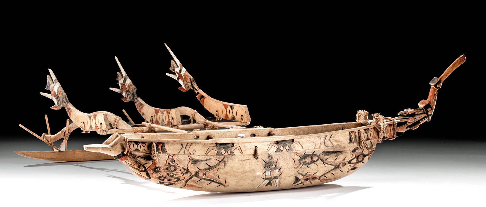 Large Early 20th C. Papua New Guinea Wood Canoe Model: Oceania, Papua New Guinea, ca. early to mid 20th century CE. This is a special one! A large, beautifully carved and painted wood model of an outrigger canoe featuring a large fishing platform and wond