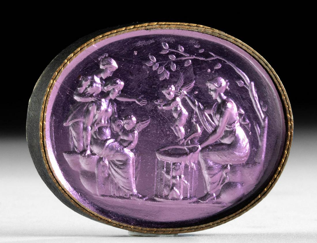 18th C. Neoclassical Glass Intaglio Muses & Cherubs: Northern Europe, Neoclassical period, ca. 18th to early 19th century CE. A striking purple glass intaglio depicting a group of three draped women, perhaps Muses, two seated on rocky outcroppings and o