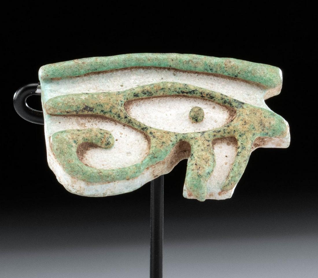 Egyptian Glazed Faience Wadjet Amulet: Egypt, Late Dynastic to Ptolemaic Period, ca. 664 to 30 BCE. A mold-formed faience amulet depicting a wadjet (or wedjat, "Eye of Horus"), an ancient ocular symbol of protection. The eye components are
