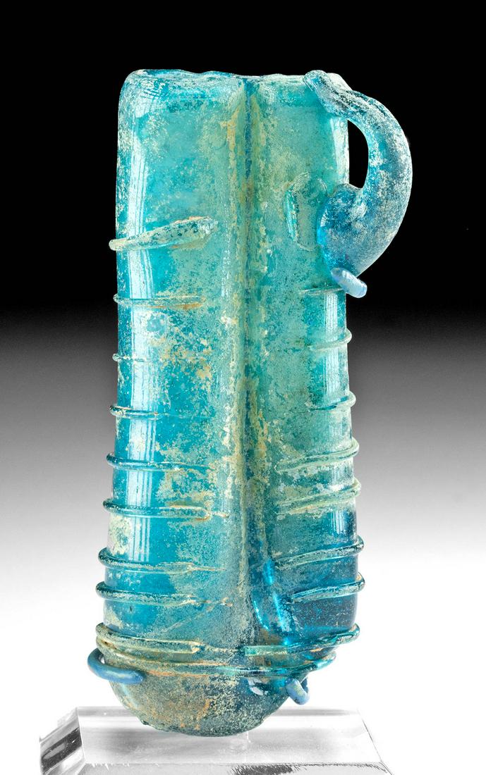 Roman Glass Double Unguentarium w/ Trailing Details: Roman, Imperial Period, ca. late 3rd to early 5th century CE. A marvelous example of a double unguentarium, free-blown from semi-translucent glass of a vibrant turquoise hue, used by women for contain
