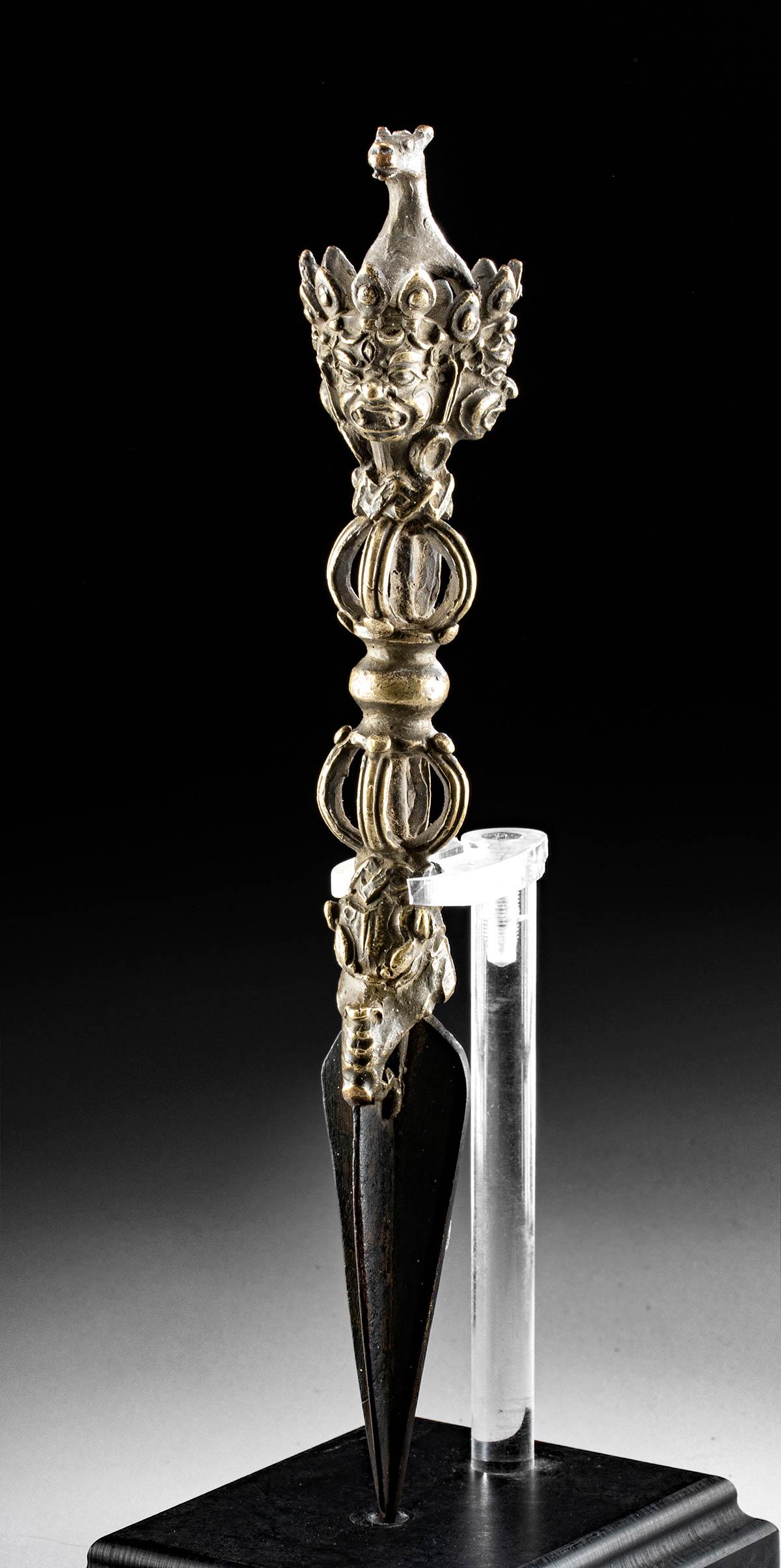 19th C. Tibetan Brass Phurba Dagger: Central Asia, Tibet, ca. 19th century CE. A lovely cast-brass phurba dagger (also known as a magic dagger) in the traditional form of a three-sided stake. The handle takes the form of a vajra (also do