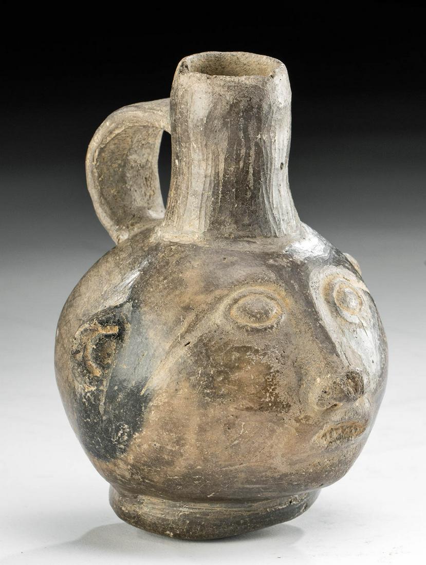 Chimu-Inca Blackware Portrait Vessel: **Originally Listed At $125** Pre-Columbian, Northern to Central Peru, Chimu-Inca culture, ca. 1200 to 1500 CE. A highly burnished blackware pottery vessel with a slightly rounded but stable base, the