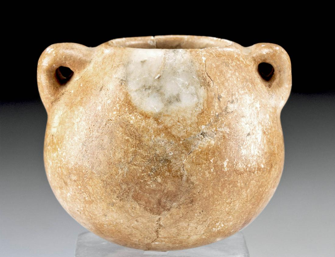 Gorgeous Egyptian Alabaster Jar w/ Lug Handles: Egypt, Late Dynastic Period, 26th to 31st Dynasty, ca. 664 to 332 BCE. A squat jar of a round-bottomed form with a smooth shoulder that tapers to shape the thin rim. Presented along the shoulder is a 
