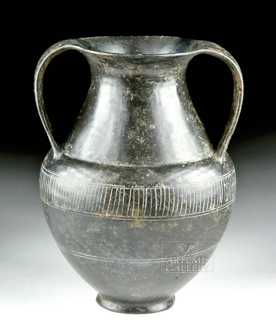 Etruscan Bucchero Amphora w/ Incised Striations: Classical World, Italy, Etruria, ca. early 6th century BCE. A wonderful wheel-thrown pottery amphora with a petite circular base, an apple-shaped body with a rounded shoulder, a conical neck with a fl